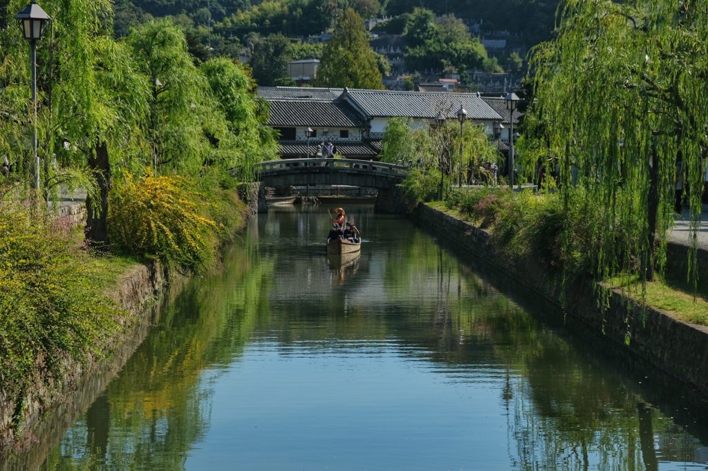 Une barque devant le pont du canal du quartier historique de Kurashiki